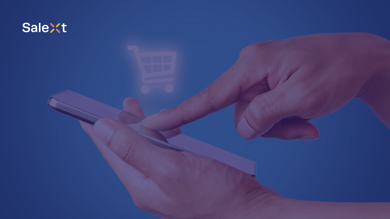 A person's hands holding a smartphone and tapping its screen, with a shopping cart icon illustration above it and a company logo in the corner