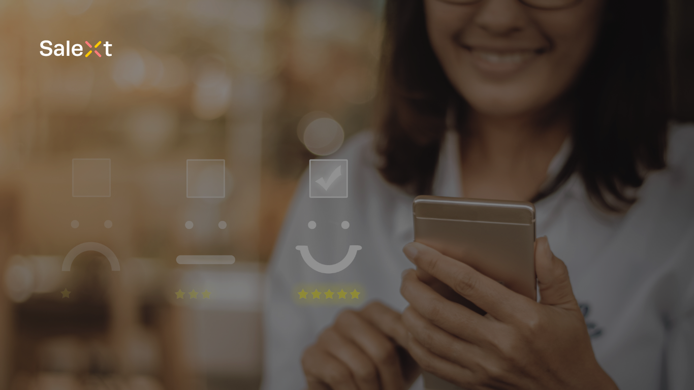 A smiling woman holds and looks at a smartphone, overlaid with graphics of satisfaction rating icons and a SaleXt logo