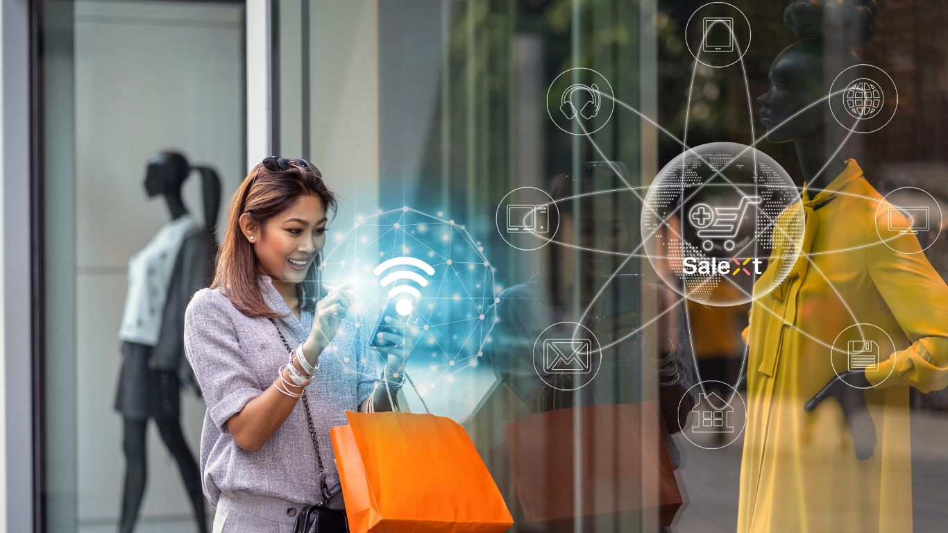 A woman holding a shopping bag stands outside a storefront window using a smartphone, with a digital graphic overlay of connectivity icons and the word SaleXt superimposed on the image